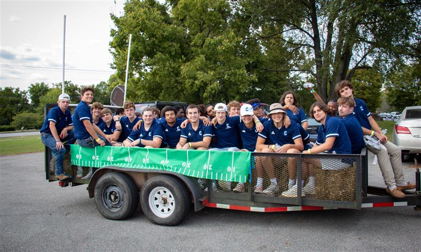 Students celebrate while on a homecoming parade float